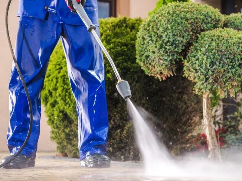Man pressure washing concrete in Atlanta and Kennesaw, GA