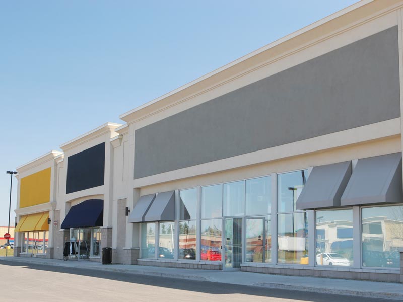 Exterior view of a commercial building adorned with yellow awnings in Atlanta, GA