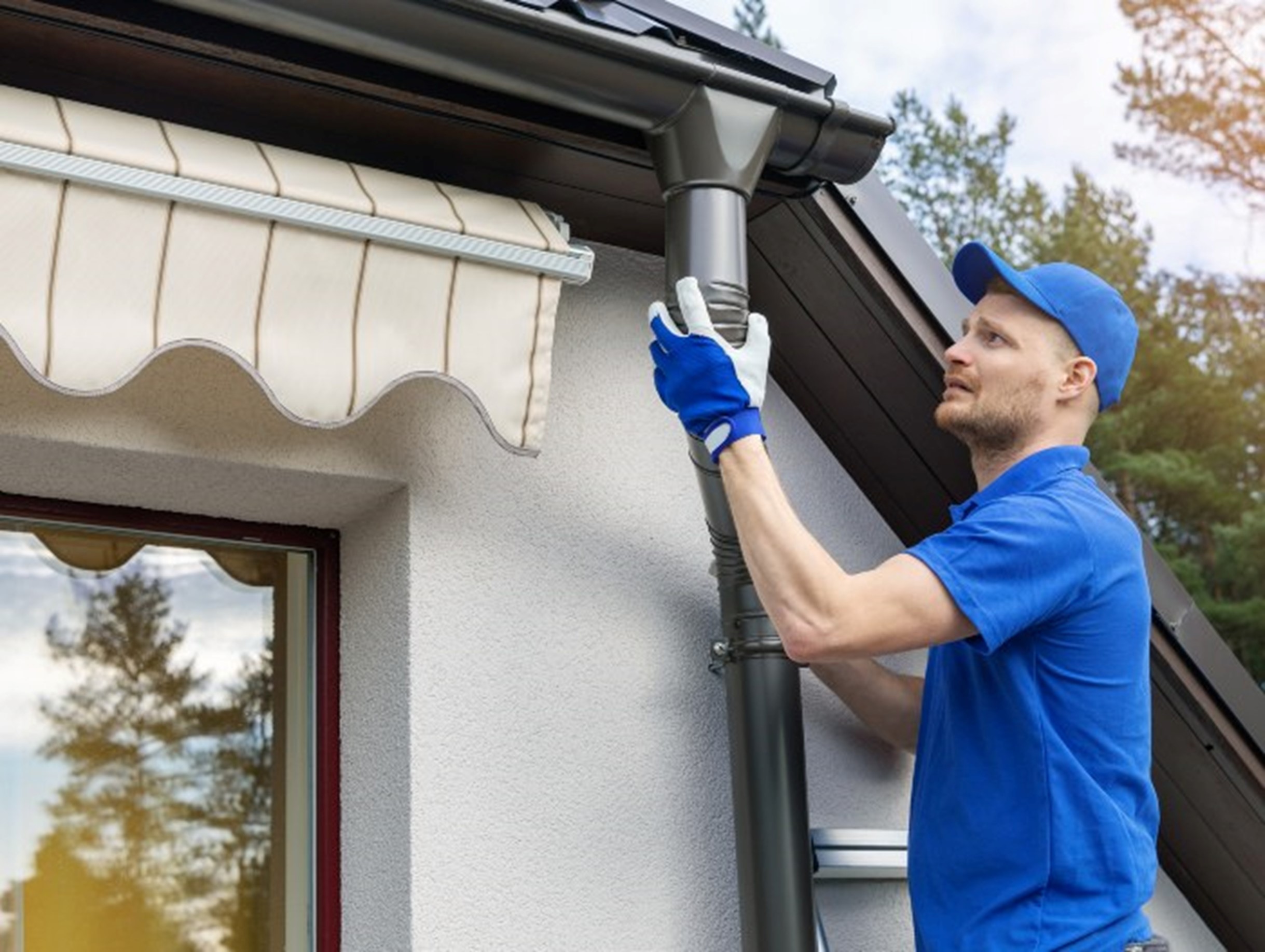 Field Manager Installing Gutter in Atlanta, GA - Dixon Painting