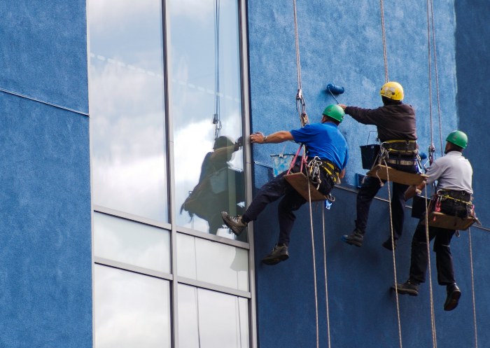 A group of team members painting the commercial buildings' walls in Atlanta and Marietta, GA