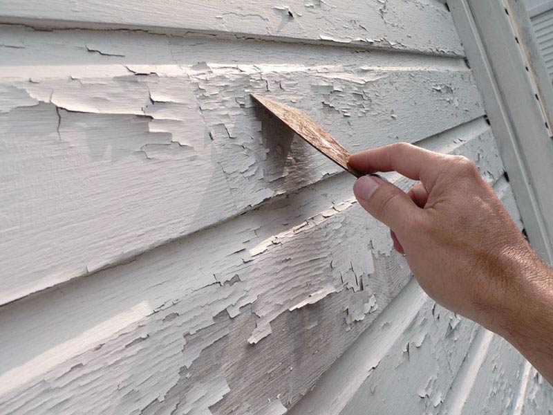A person removing paint from the wall in Atlanta and Kennesaw, GA