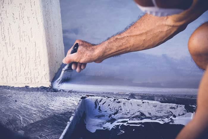 A person painting a surface in Atlanta and Kennesaw, GA