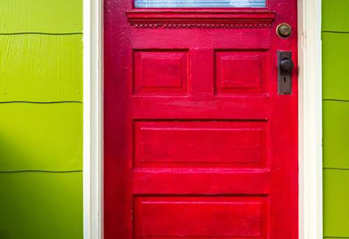 A red door with a green wall in Atlanta and Kennesaw, GA